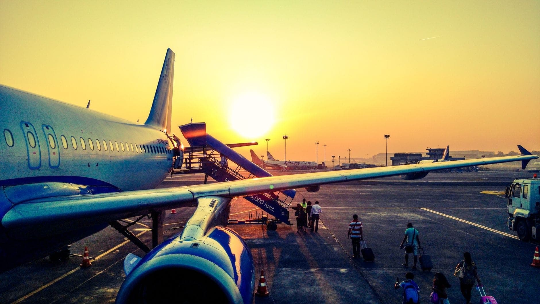 Passengers boarding a flight at sunrise, the early-morning departures Maxi Cab Perth covers for FIFO workers through Perth Airport